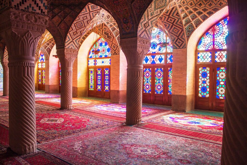 Beautiful prayer area inside a mosque, featuring intricate Islamic architecture and a peaceful ambiance symbolizing faith and devotion